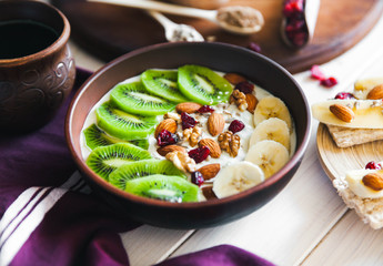Yogurt with different fruits on a wooden background. Useful food, diet, organic.