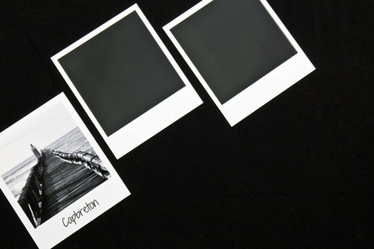 retro vintage three instant photo frames cards on black background with a photo of capbreton breakwater in black and white with copy space text