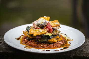 Vegetable stack - pumpkin, zucchini, red capsicum, eggplant and mushroom cooked in a tomato, onion, and garlic sauce topped with parmesan cheese