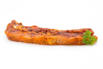 Spicy marinated spare ribs barbecued on the white background.