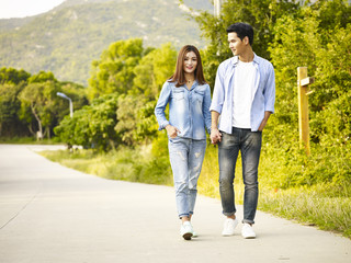 young asian couple taking a walk - Powered by Adobe