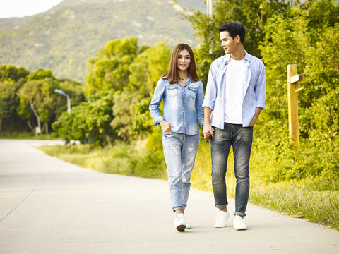 young asian couple taking a walk