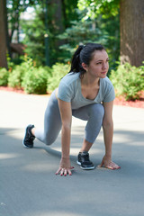 Exercise outdoors. Beautiful young girl is exercising in the park. Exercise stress.
