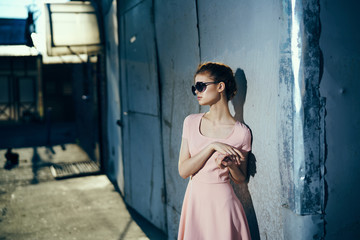 Woman in glasses on the background of the old wall