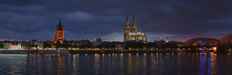 Fototapeta na wymiar Panorama of the old evening Cologne. Rhine, railway bridge