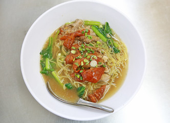 Roasted Duck nooddle in the bowl with chopsticks and spoon.