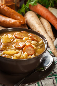 Traditional Polish split pea soup with sausage, bacon and potatoes