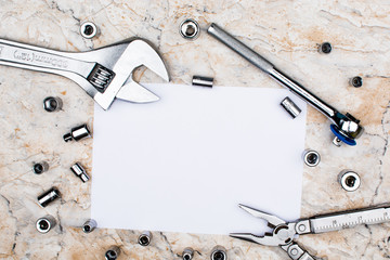 plumbing tools and empty sheet of paper. Studio shot on marble background. Father's day composition 