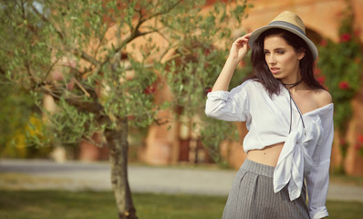 Naklejka premium Beautiful woman resting in the summer the Italian garden