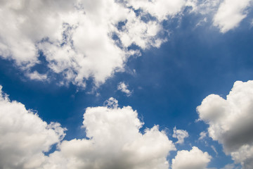 Sunny day with fluffy clouds in the blue sky