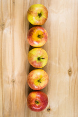 Red apples on a wooden table.
