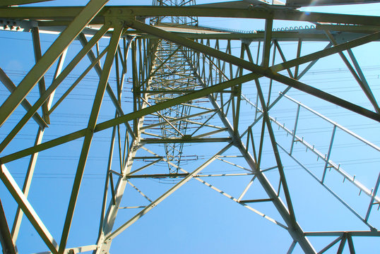 Strommast vor blauem Himmel von unten