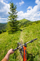 Fototapeta na wymiar Biker is riding uphill. Carpathian mountains.