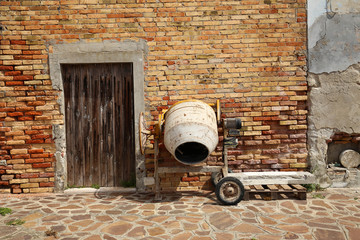 Concrete mixer at the brick wall