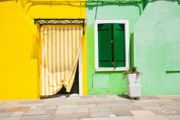 Colourful buildings lining cannal, Island of Burano, Venice Italy