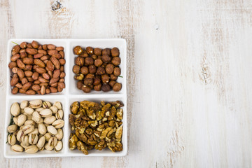 Obraz na płótnie Canvas Bowl with nuts on a wooden table