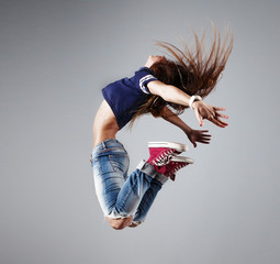 modern young beautiful dancer posing on a studio background