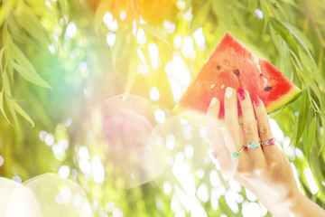 Beautiful hand with many rings and sweet pink melon © marbenzu