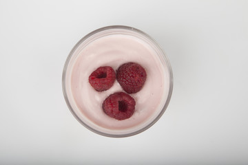 glass of fresh berries and yogurt isolated on white background