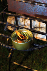 burning candle stands in wrought iron grille grill