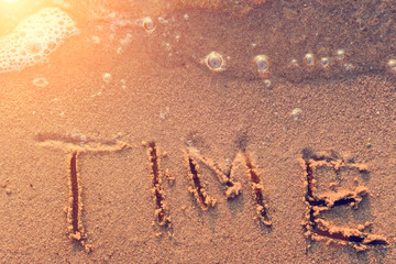 word Time written in the sand