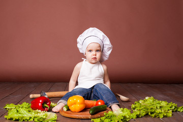 boy chef prepares carrots, pepper, Tomato Cucumber
