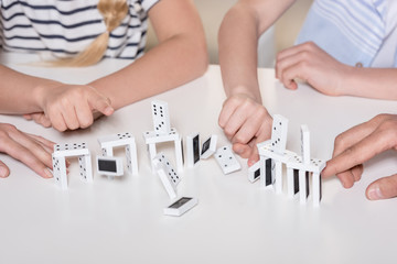 family playing with domino pieces, cropped image