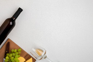 Wine, glasses and corkscrew over white background. Top view