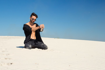 Fototapeta na wymiar A guy kneeling sand white sand