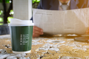 coffee cup clock and newspaper work on table