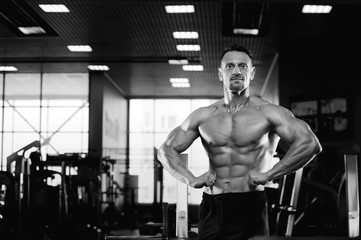 Fototapeta na wymiar Male fitness model showing muscular body