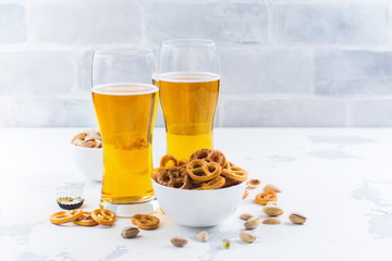 Beer and snacks on white background