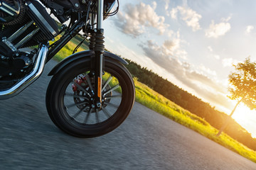 Detail of front wheel of high power motorbike in sunset