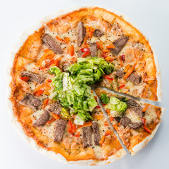 Sliced pizza with beef and salad