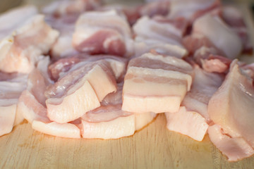Raw pork on a cutting board wood table background