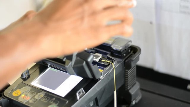 technician use ool for connecting optical fibers. Welding of optical fibers.
