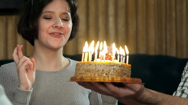Young girl blowing candles on birthday cake