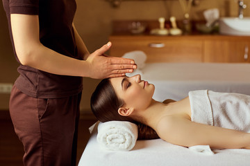 Obraz na płótnie Canvas Facial massage for young woman in spa salon.