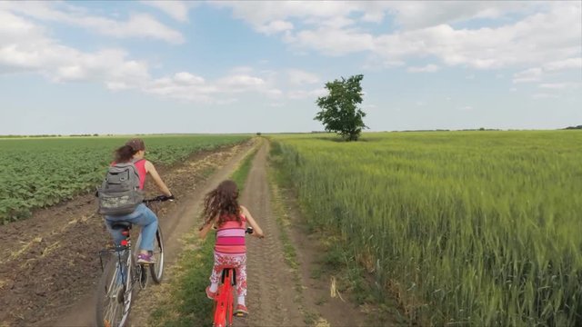 A sports family on bicycles. Cyclists in the field.