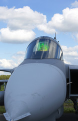 Fototapeta na wymiar Front view of the modern tactical jet fighter cockpit. Head Up Display in the glass reflecting.