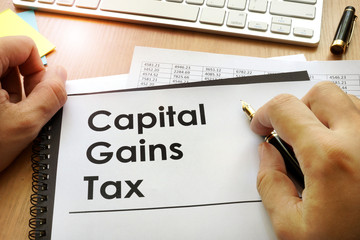 Hands holding documents with title capital gains tax CGT. - obrazy, fototapety, plakaty