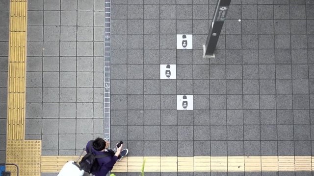 Pedestrians walking holding umbrellas in slow motion in aerial view
