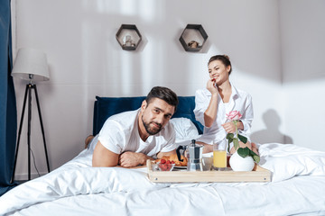 Happy couple in love having breakfast in bed