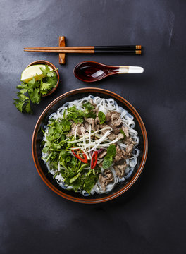 Pho Bo vietnamese Soup with beef on dark background