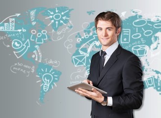 Businessman working on digital tablet.