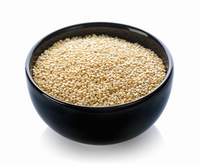 Quinoa in black bowl on white background