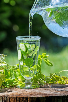 Glass with mineral water with cucumber and mint - home made lemonade