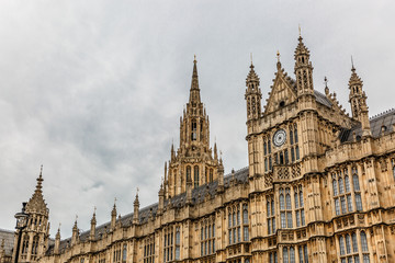 Fototapeta na wymiar Palace of Westminster fragment (known as Houses of Parliament) located on bank of River Thames in City of Westminster. London