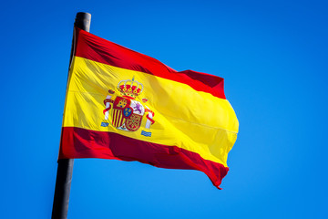 Flag of Spain Over a Blue Sky