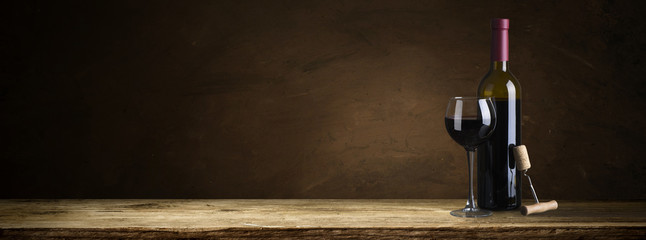 corkscrew and wooden barrel, vineyard on background